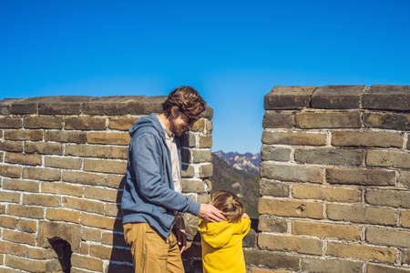 Happy cheerful joyful tourists dad and son at Great Wall of Chinaの写真素材