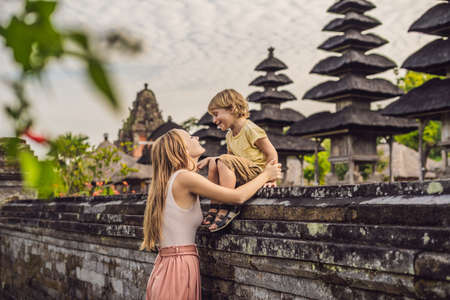 Mom and son tourists in Traditional balinese hindu Temple Taman Ayun in Mengwi. Bali, Indonesia Traveling with children conceptの写真素材