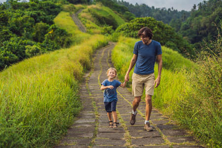 Dad and son tourists in Campuhan Ridge Walk , Scenic Green Valley in Ubud Bali. Traveling with children conceptの写真素材