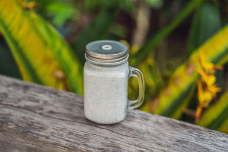 Healthy layered dessert with chia pudding in a mason jar on rusticの写真素材