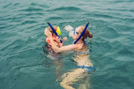 happy mother and son snorkeling at the shipの写真素材