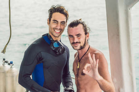 Happy diver returns to the ship after diving
