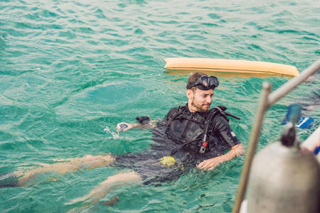Divers on the surface of water ready to dive