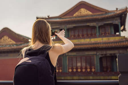 Enjoying vacation in China. Young woman in Forbidden City. Travel to China concept.の写真素材