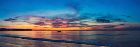 gold sunset over beach with wave splashes in summer of Thailand