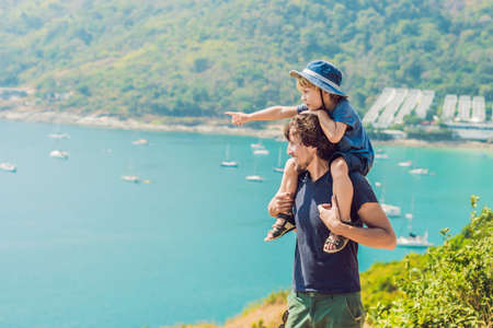 Father and son in the background of Promthep cape and Yanui beach. Phuket, Thailand. Traveling with children conceptの写真素材