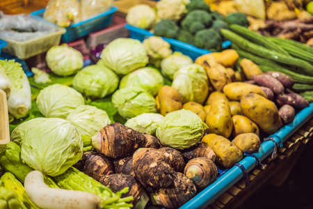 Assortment of fresh vegetables at market counter, vegetable shop, farmer marketplace. Organic, healthy, vegetarian diet food concept. Selective focus.の写真素材