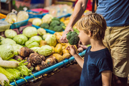 Dad and son are tourists on Walking street Asian food marketの写真素材