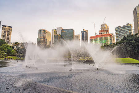 Fountain on the lake in the evening, near by Twin Towers with city on background. Kuala Lumpur, Malaysia.の写真素材