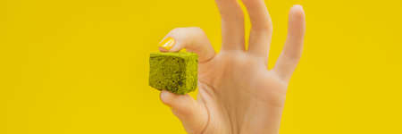Matcha candy on yellow background. Homemade Matcha. BANNER, LONG FORMATの写真素材