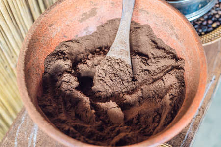 Ground coffee in a bowl with a large spoon