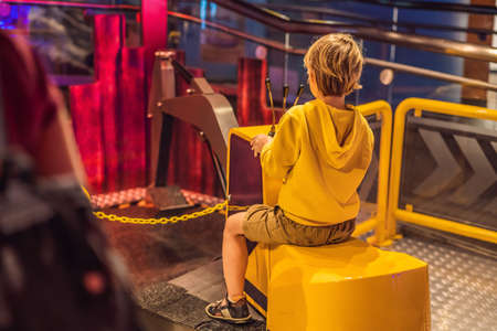 The boy is playing with a big toy excavator. Construction concept. Child development conceptの写真素材