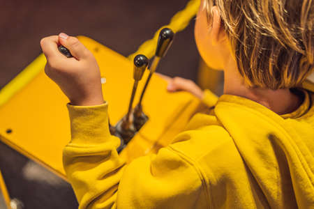 The boy is playing with a big toy excavator. Construction concept. Child development concept.