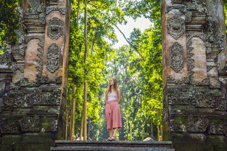 Young woman traveler discovering Ubud forest in Monkey forest, Bali Indonesia. Traveling with children conceptの写真素材
