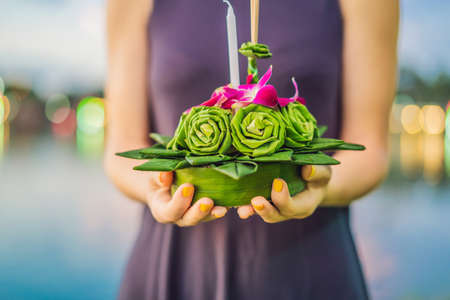 Young woman celebrates Loy Krathong, Runs on the water.の写真素材