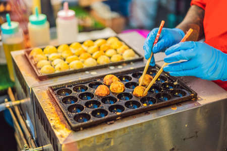 Street food seller selling seafood in the night market. Street food is ready-to-eat food or drinks sold by a hawkerの写真素材