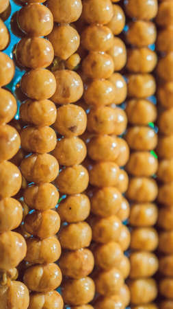 Home made meat salami sausage at street market hanging in line under sunlight to make good tasty. sausages hang outdoor VERTICAL FORMAT for mobile story or stories size.の写真素材