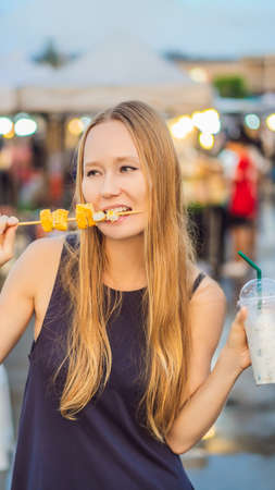 Young woman tourist on Walking street Asian food market VERTICAL FORMAT for mobile story or stories size. Mobile wallpaperの写真素材