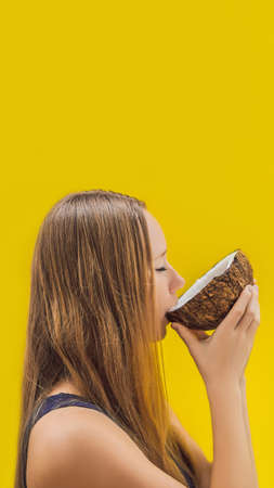 Young woman doing oil pulling over yellow background. VERTICAL FORMAT for mobile story or stories size. Mobile wallpaperの写真素材