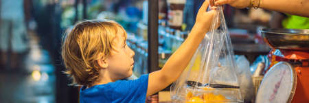 Young boy tourist on Walking street Asian food market BANNER, LONG FORMATの写真素材