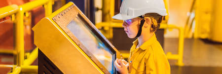 Boy operator recording operation of oil and gas process at oil and rig plant, offshore oil and gas...