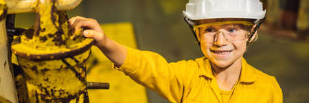 Boy operator recording operation of oil and gas process at oil and rig plant, offshore oil and gas...