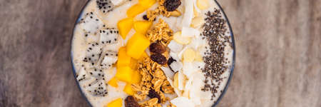Smoothie bowls made with mango, banana, granola, grated coconut, dragon fruit, chia seeds and mint...