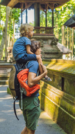 Dad and son travelers discovering Ubud forest in Monkey forest, Bali Indonesia. Traveling with children concept VERTICAL FORMAT for mobile story or stories size. Mobile wallpaperの写真素材