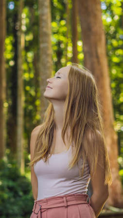 Young woman traveler discovering Ubud forest in Monkey forest, Bali Indonesia. Traveling with children concept VERTICAL FORMAT for mobile story or stories size. Mobile wallpaperの写真素材