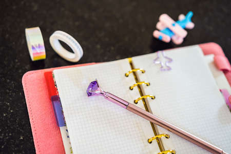 Notepad and stationery on a black background. Planner for business and study. Fans of stationeryの写真素材