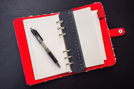 Notepad and stationery on a black background. Planner for business and study. Fans of stationeryの写真素材