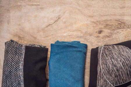 Everything for sports turquoise, blue shades on a wooden background. Yoga mat, sport shoes...