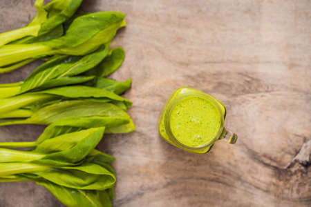 Ginger green apple smoothie on concrete background. It can be used as a background