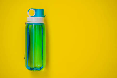 Everything for sports turquoise, blue shades on a yellow background. Yoga mat, sport shoes sportswear and bottle of water. Concept healthy lifestyle, sport and diet. Sport equipment. Copy spaceの写真素材