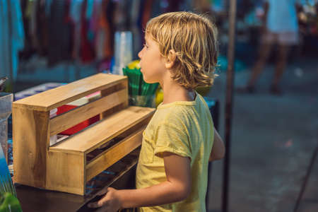 Young boy tourist on Walking street Asian food marketの写真素材