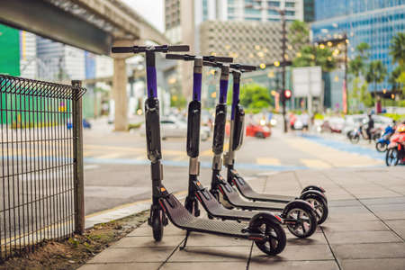 Electric scooters for rent. urban transport. Electric Ride Sharing Scooters Lined Up and Ready to Rentの写真素材