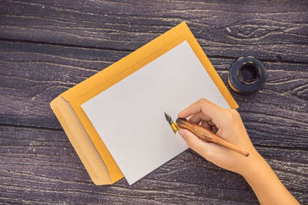 Womens hands in a wooden  holding a signboard, drawing block, paper, mockup