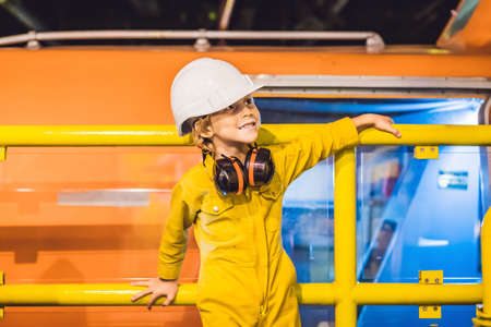 Boy operator recording operation of oil and gas process at oil and rig plant, offshore oil and gas industry, offshore oil and rig in the sea, operator monitor production process, routine daily recordの写真素材