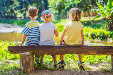 Children rest during a hike in the woodsの写真素材