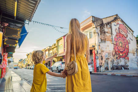 Mom and son tourists on the Street in the Portugese style Romani in Phuket Town. Also called Chinatown or the old town. Traveling with kids conceptの写真素材