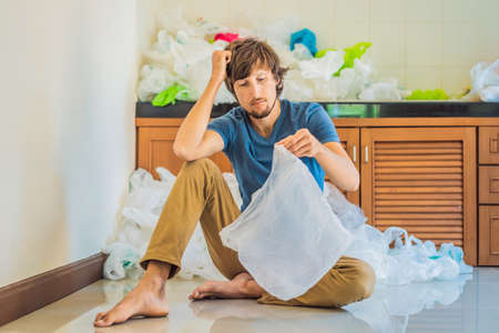 The man used too many plastic bags that they filled up the entire kitchen. Zero waste concept. The...