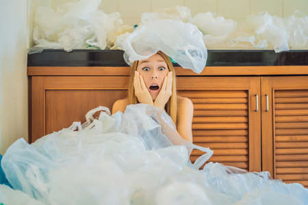 Woman used too many plastic bags that they filled up the entire kitchen. Zero waste concept. The concept of World Environment Dayの写真素材