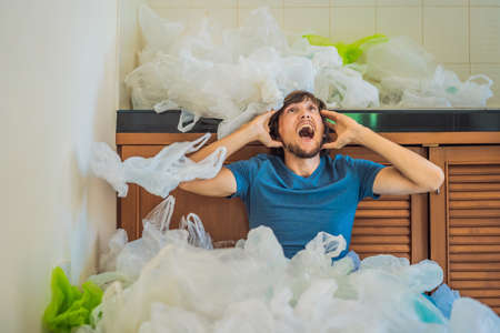 The man used too many plastic bags that they filled up the entire kitchen.