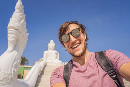 Man tourist on  of Big Buddha statue Was built on a high hilltop of Phuket Thailand Can be seen from a distanceの写真素材