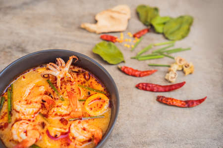 Prawn and lemon grass soup with mushrooms,Tom Yam Kung ,thai food in wooden background, top viewの写真素材