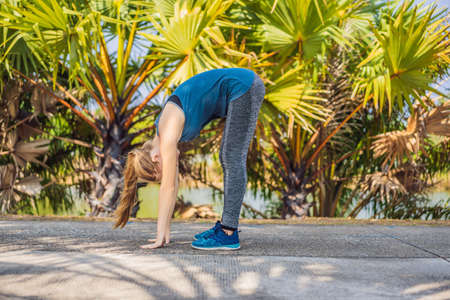 Woman doing yoga in a tropical park