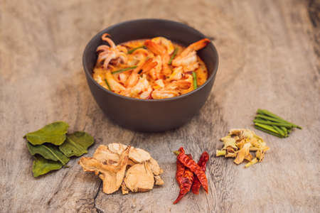 Prawn and lemon grass soup with mushrooms,Tom Yam Kung ,thai food in wooden background, top viewの写真素材
