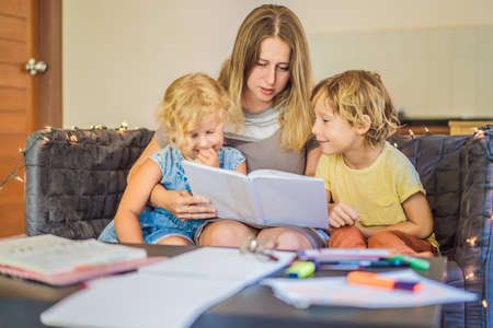 Teacher, tutor for home schooling Boy and girl at the table. Or mother, daughter and son....