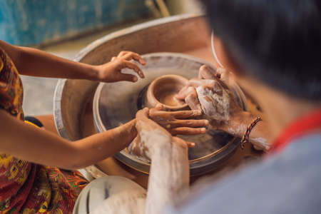 Father and son doing ceramic pot in pottery workshop.の写真素材