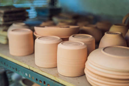 Cups on the shelves in the pottery workshop